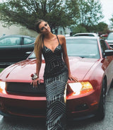 cute XO Babe sitting on the front of her mustang, ready for prom in a black sparkly prom dress