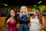 3 XO Babes in homecoming dresses laughing and having fun
